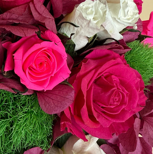 close up of pink and white roses mixed with pink hydrangeas in the small hot pink hat box