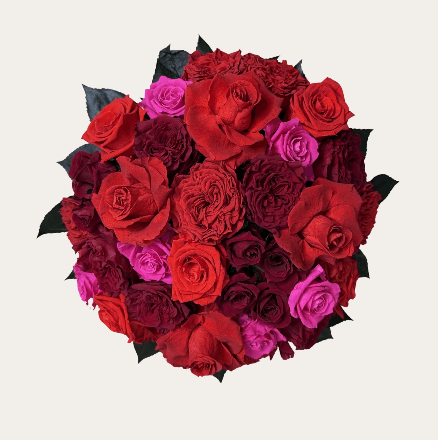 roses top view showing red and hot pink blooms arranged in a dome inside a large black hat box