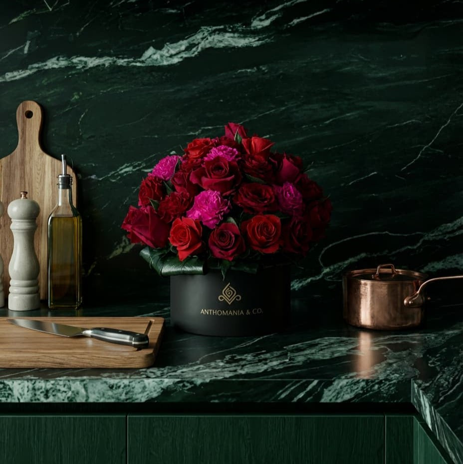 mini roses in a black small hat box placed on a kitchen countertop in a lifestyle setting
