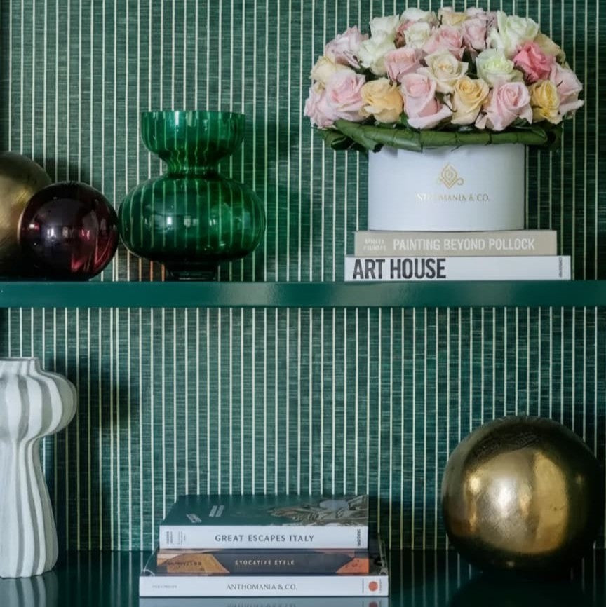 mini roses in a white small hat box placed on a bookshelf in a lifestyle setting